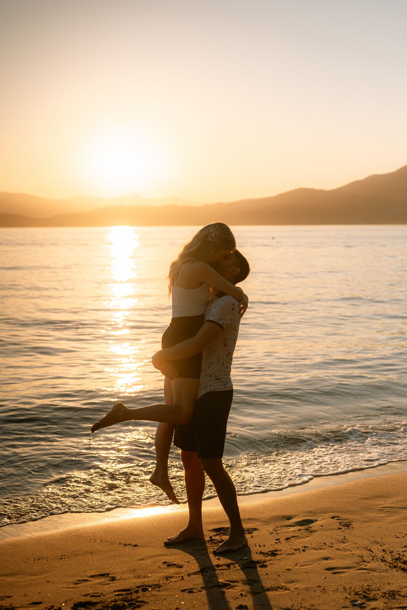 Sunset proposal photos, couple embracing on the beach
