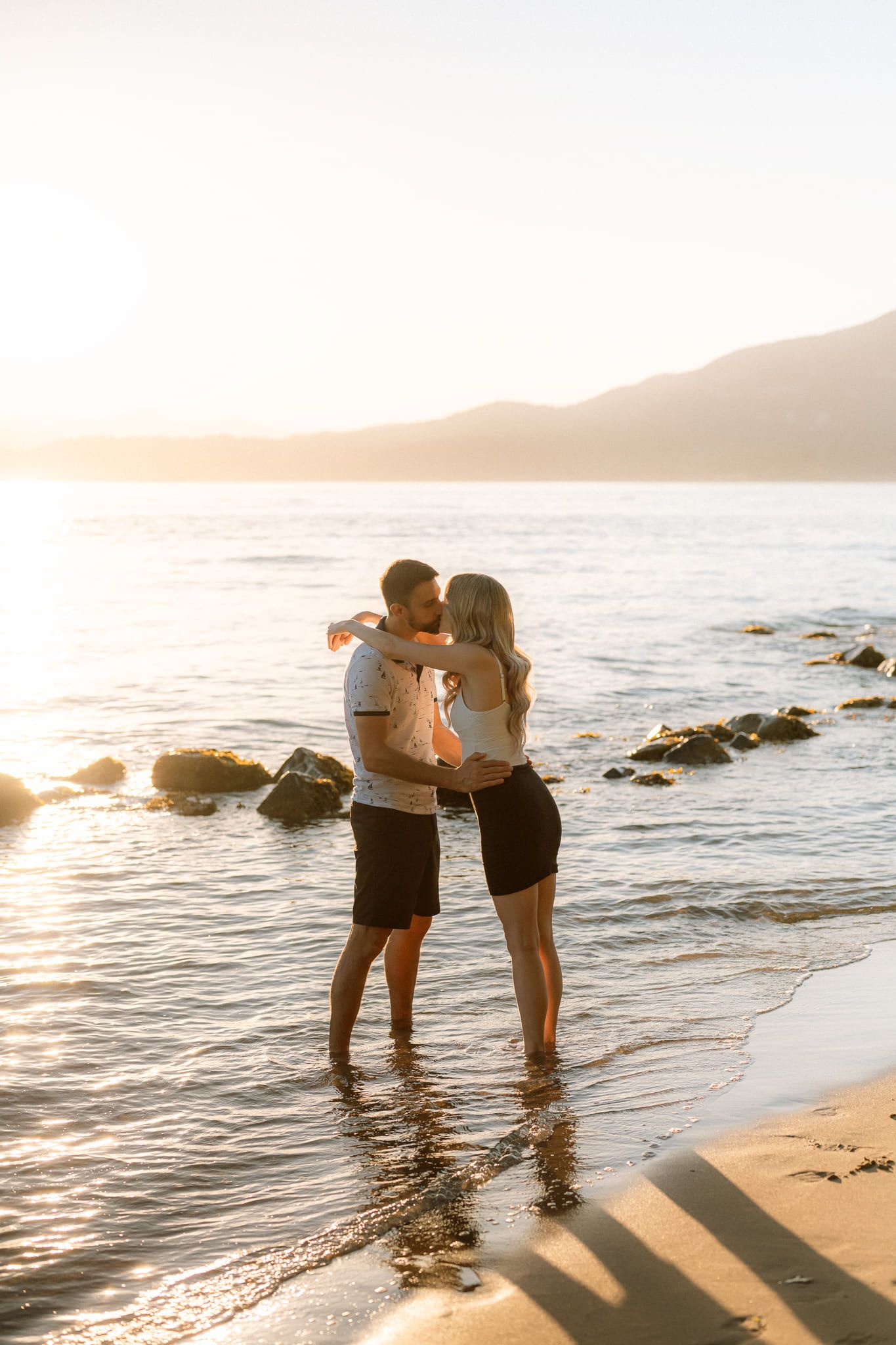 Sunset engagement photos, couple embracing on the beach