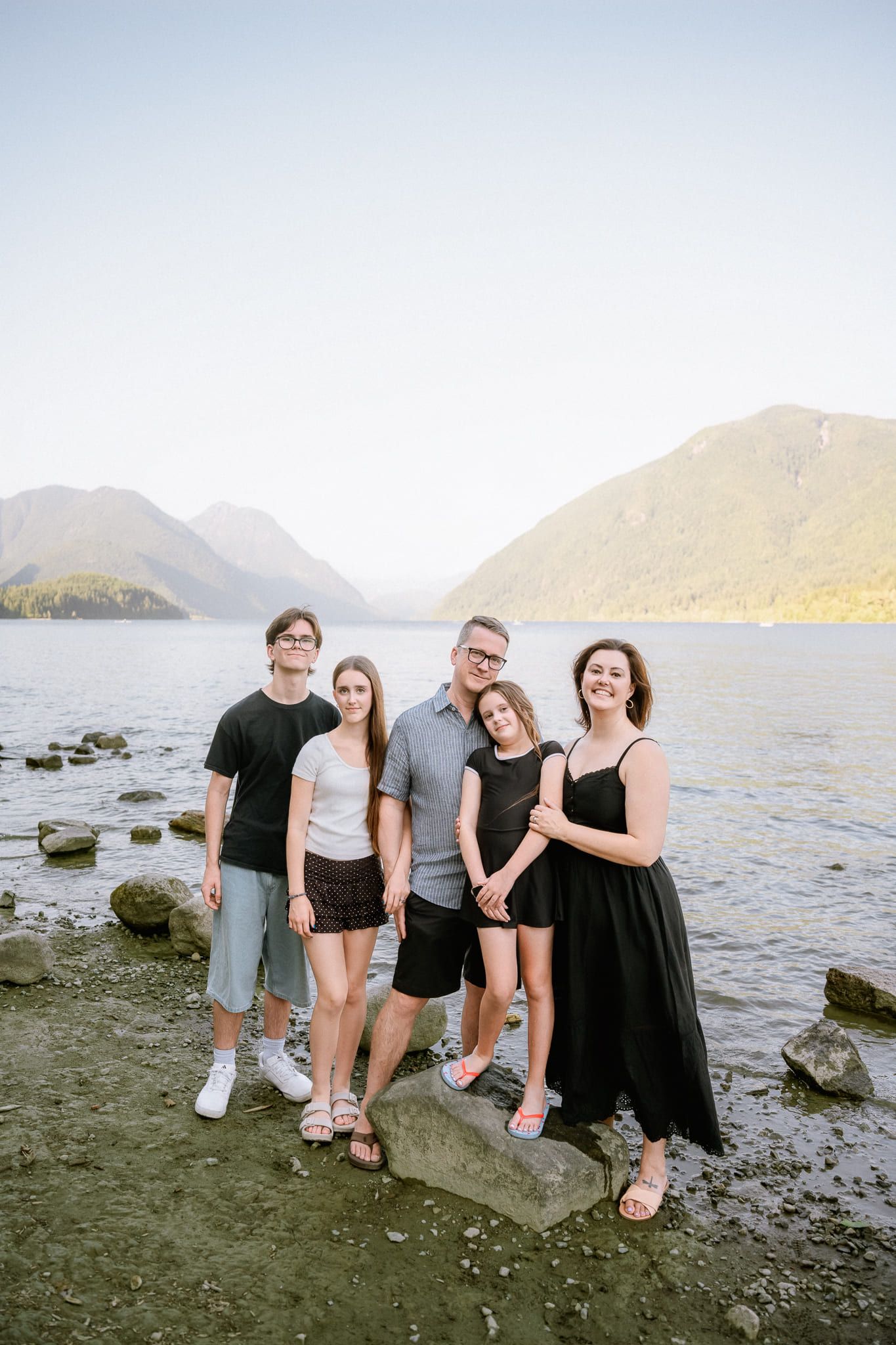 Port Moody family photos, family standing on the shore of a mountain lake