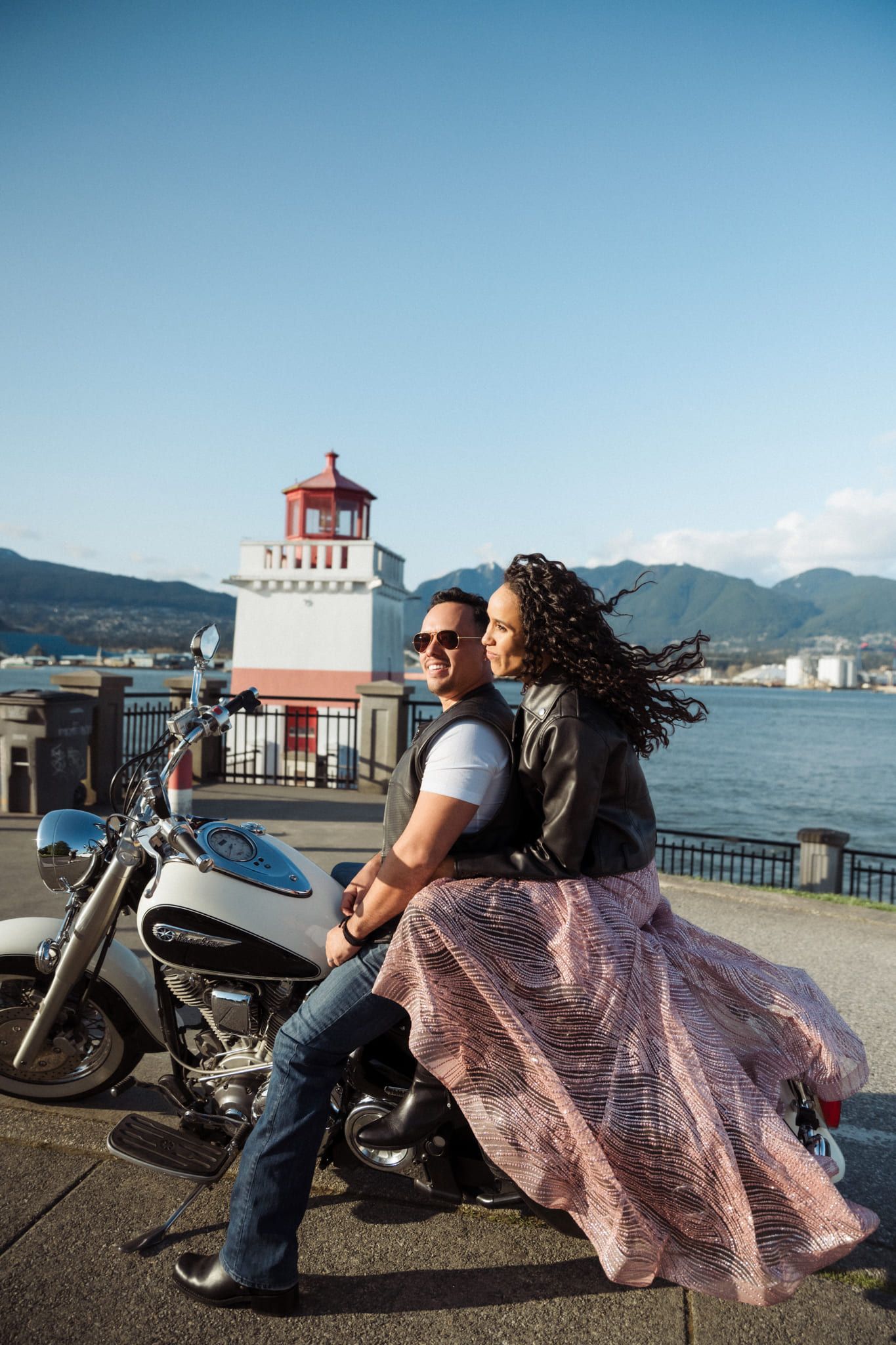 Proposal pics by the harbour and a lighthouse, couple with a motorcycle