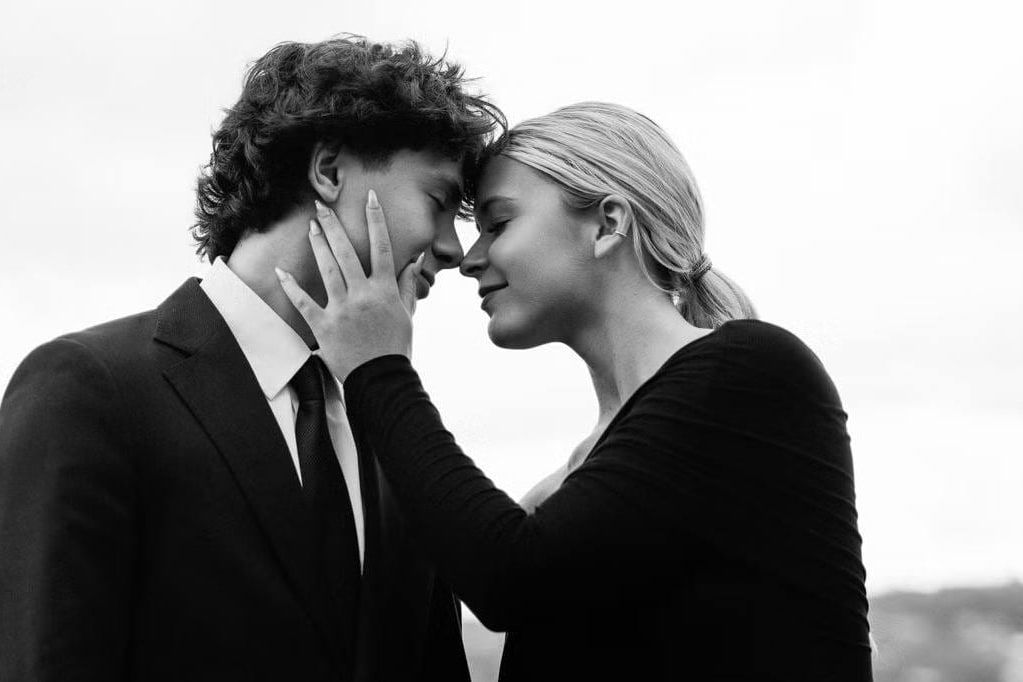 Engagement photography in Vancouver, black-and-white close-up of a couple touching foreheads, her hands on his face, he in a dark suit