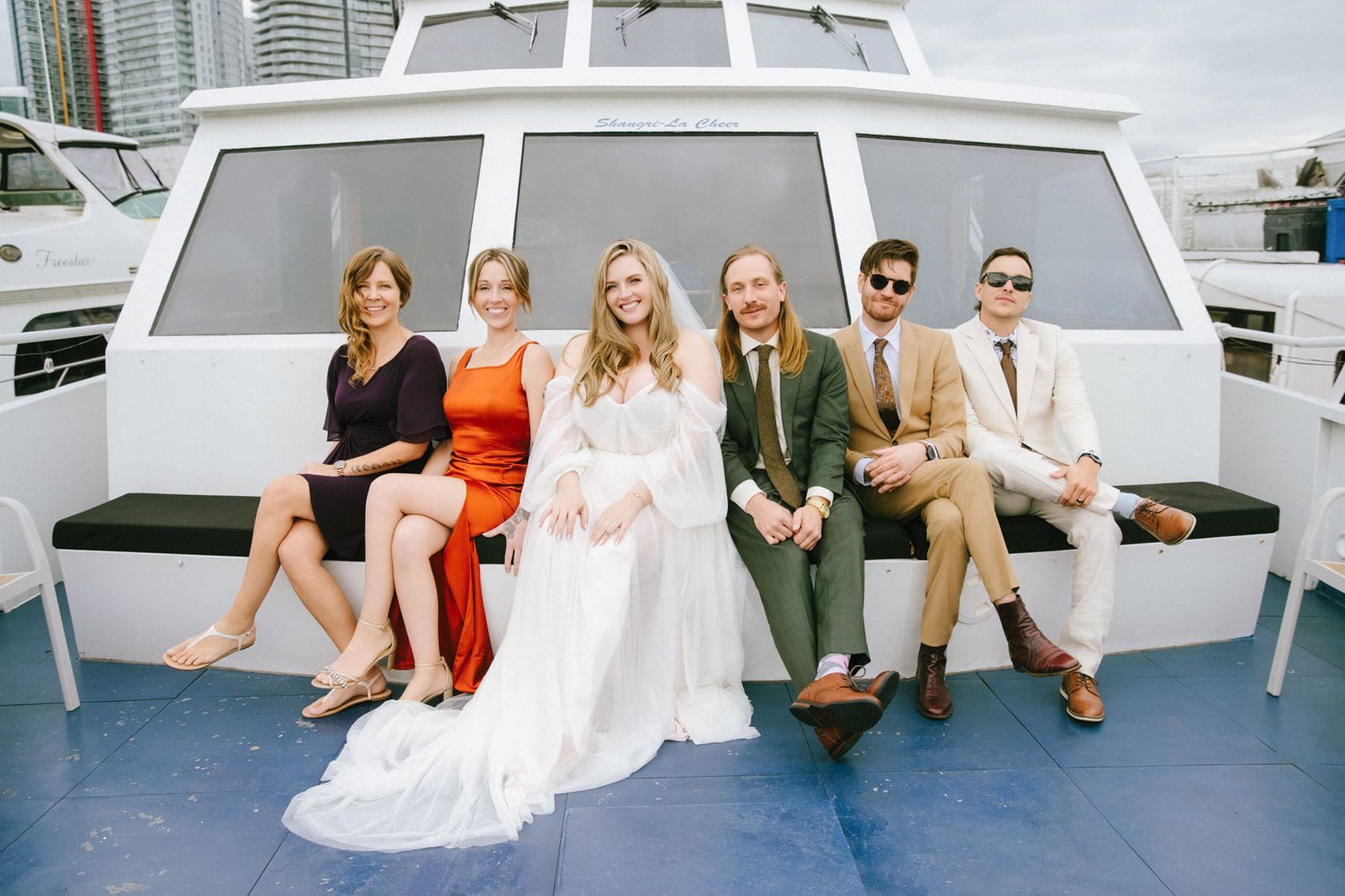 Langley wedding photography, wedding party sitting together on the deck of a yacht downtown