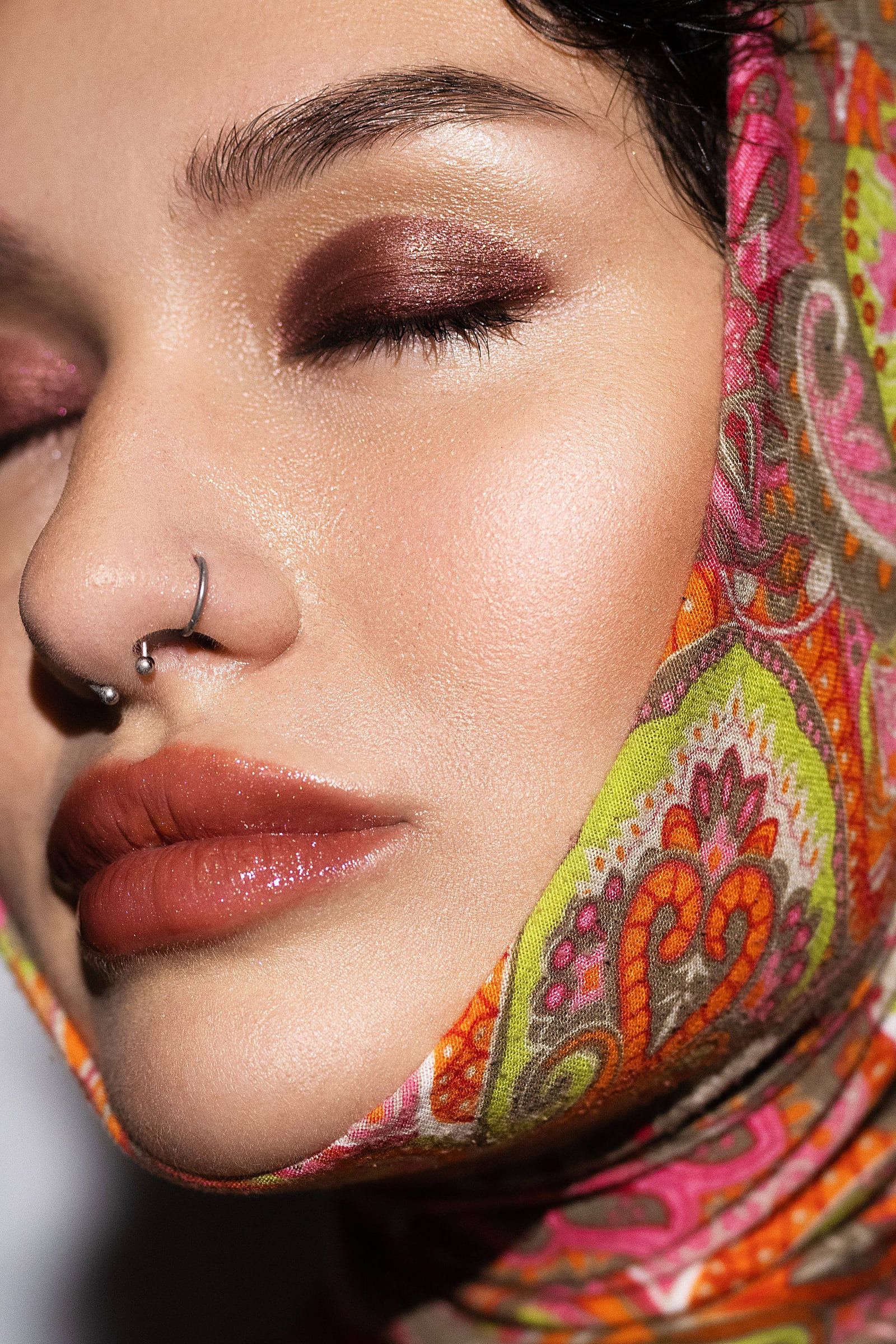 Beauty close-up of a model in a paisley headscarf, eyes closed