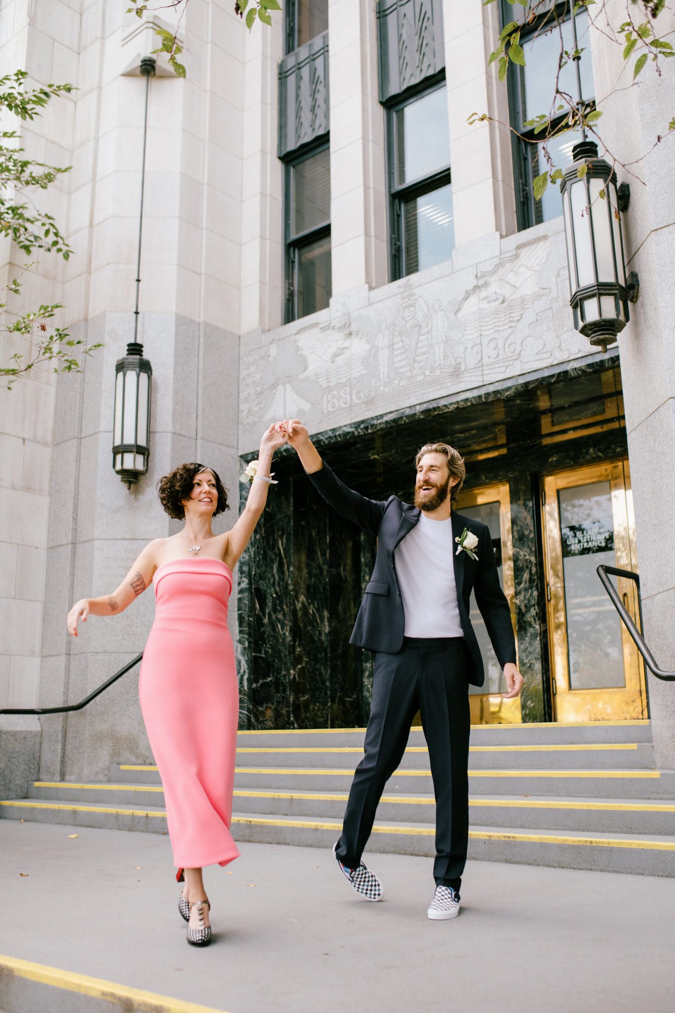 Fun wedding pictures, couple dancing on the steps of a city building