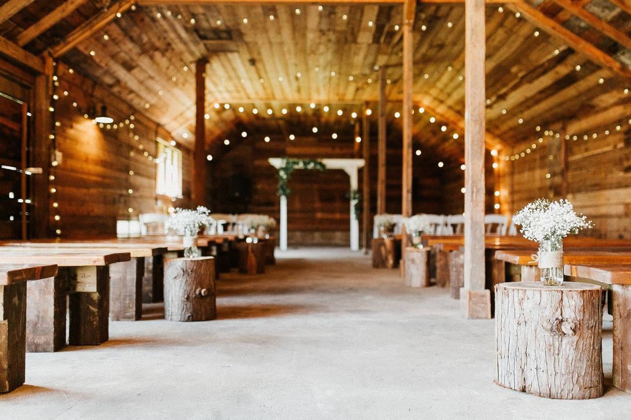 Outdoor wedding photos, barn reception set with wooden tables and string lights at Estate 248