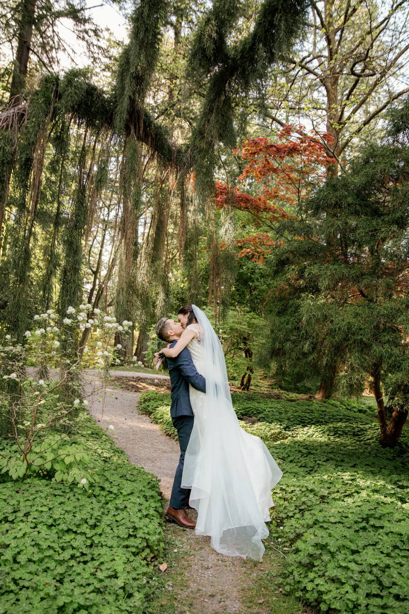 Couple embracing on a leafy garden path