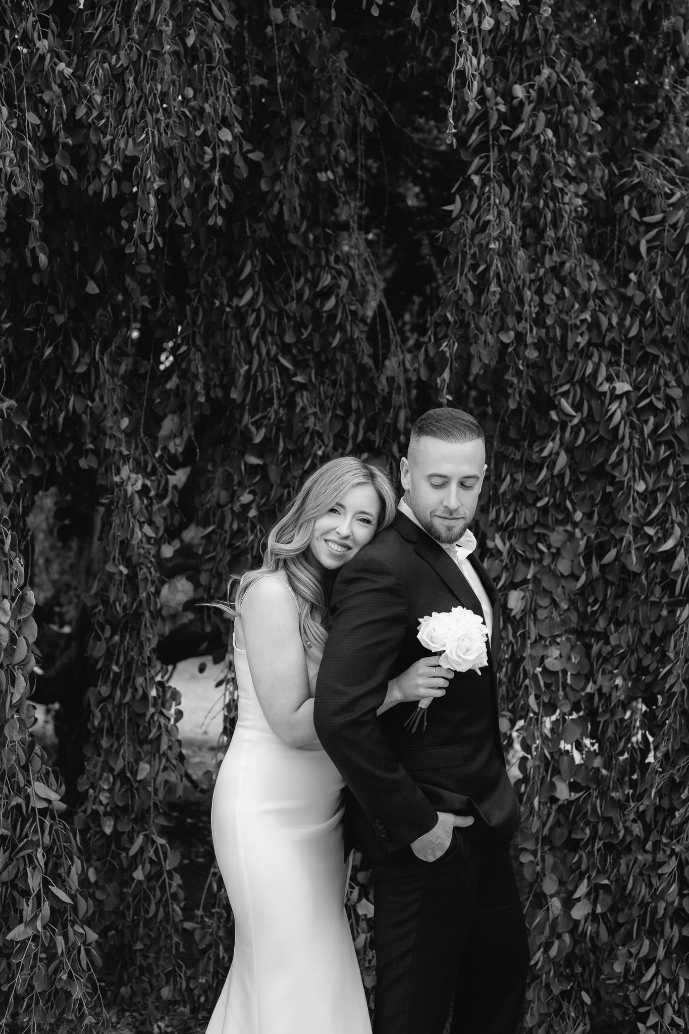 Outdoor engagement shoot in a garden, engaged couple in formal wear, in black and white