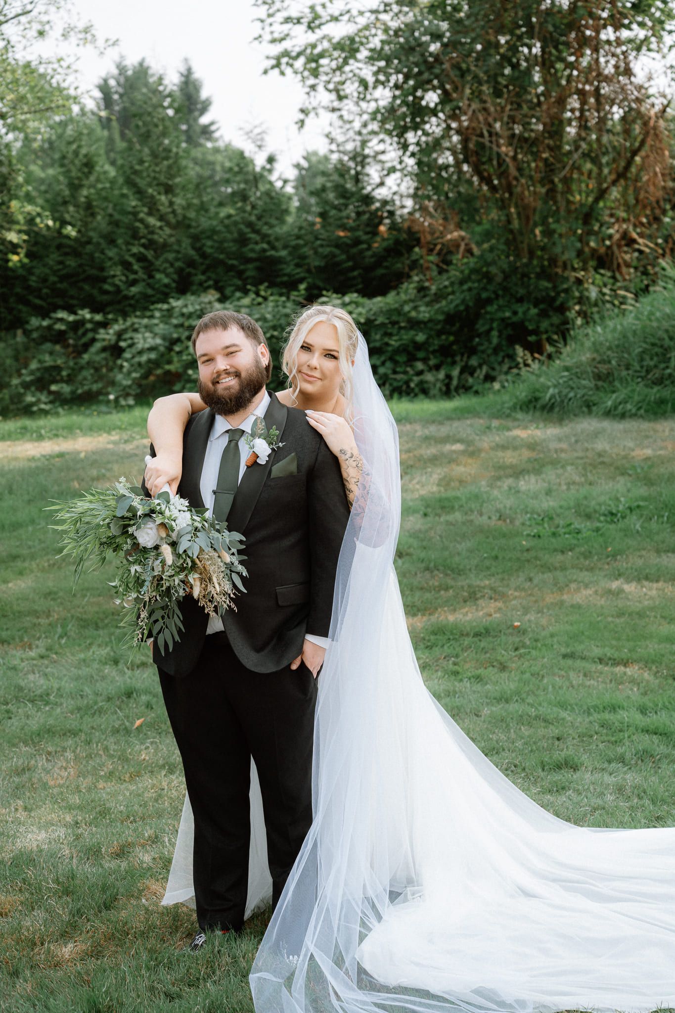 Fun wedding pictures on a garden lawn, bride and groom smiling together