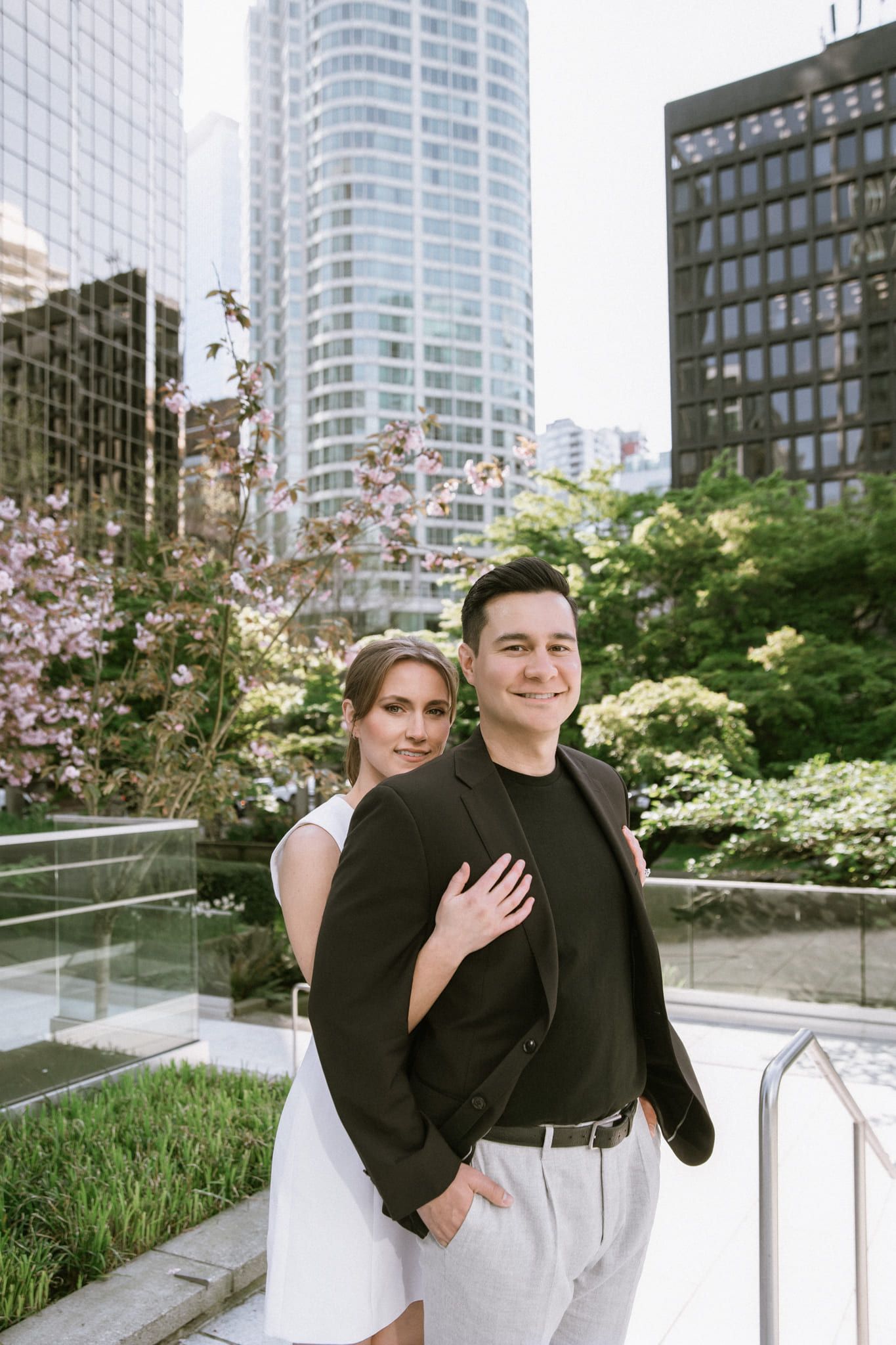 Downtown engagement photos, couple in white and black among downtown towers