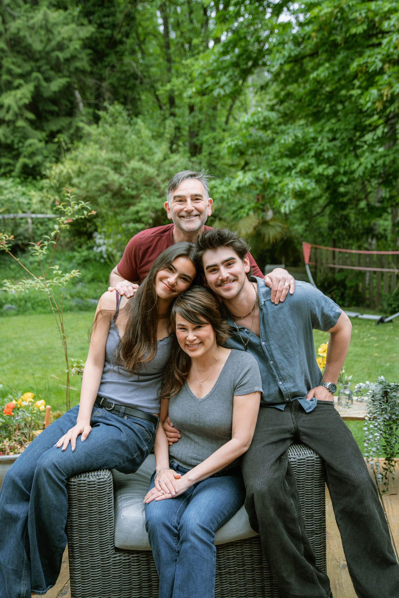 Family pictures outside, grown children and their parents hugging in a backyard garden