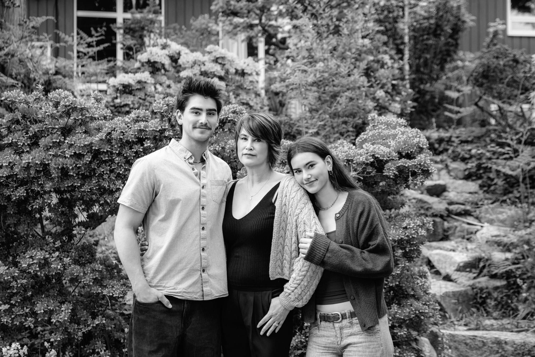 Black and white family photography in a garden, mom with her two grown children