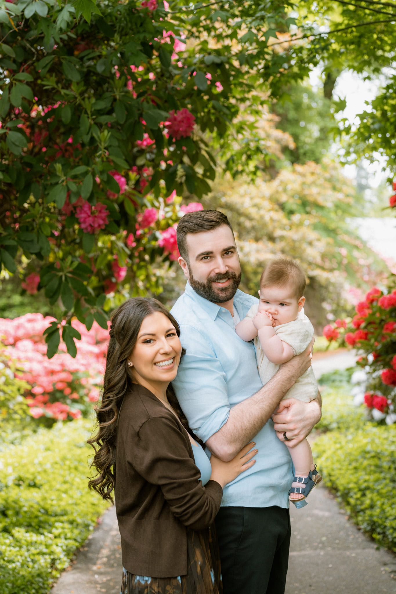 Garden family photos, parents holding their baby boy