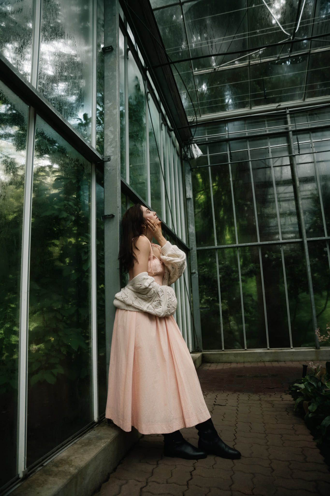 Woman in a blush gown, an editorial portrait in a glass greenhouse, by Coquitlam portrait photographer Natalie Varro