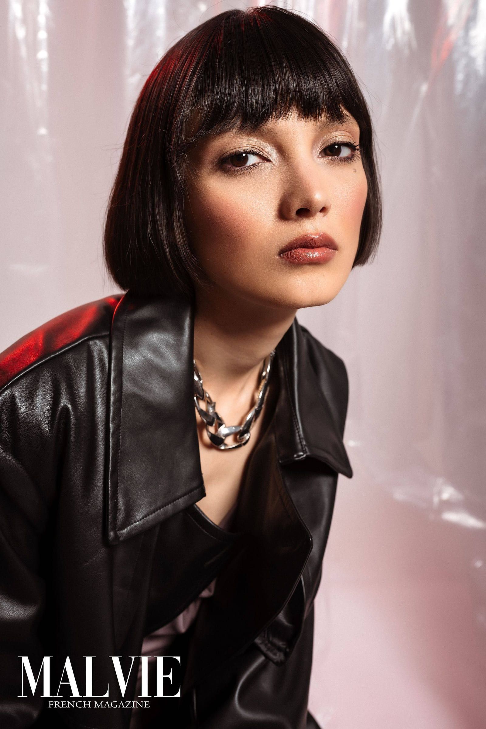Model in a black leather jacket with a gold chain, from a Malvie feature