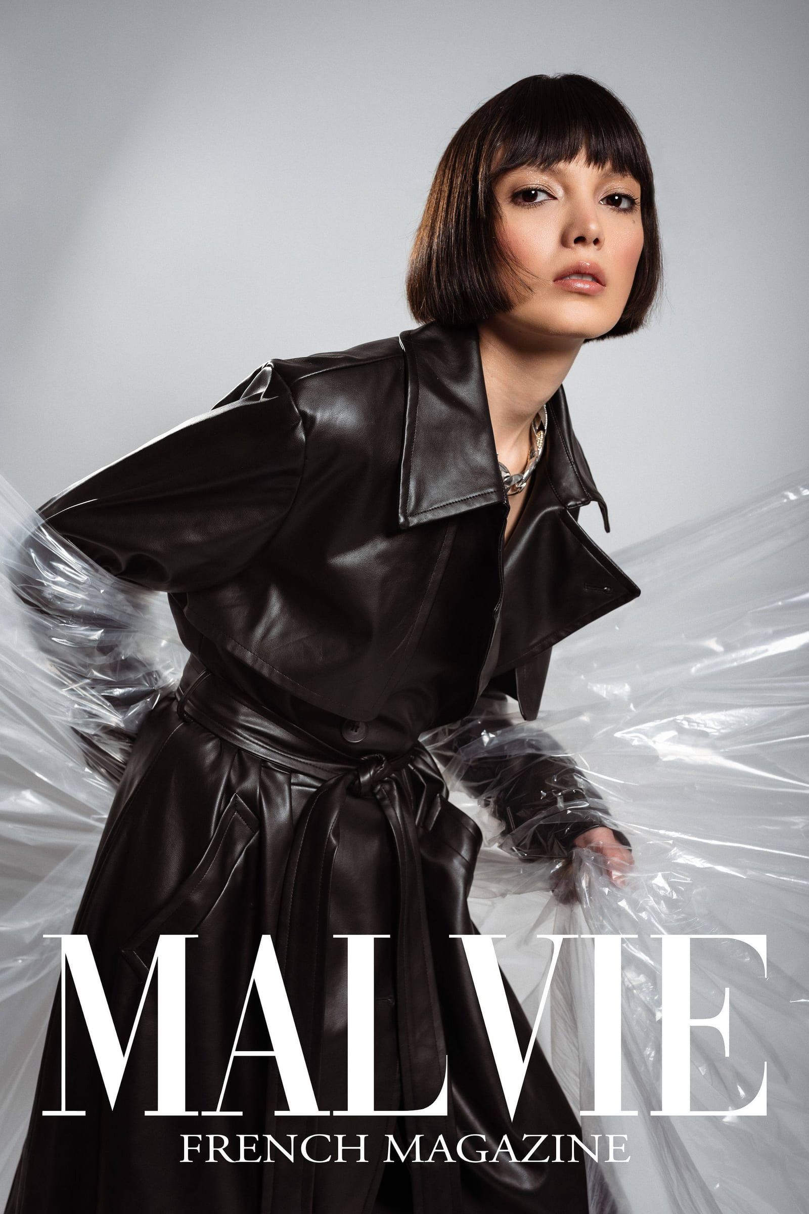 Model in a black leather trench coat on the cover of Malvie French Magazine