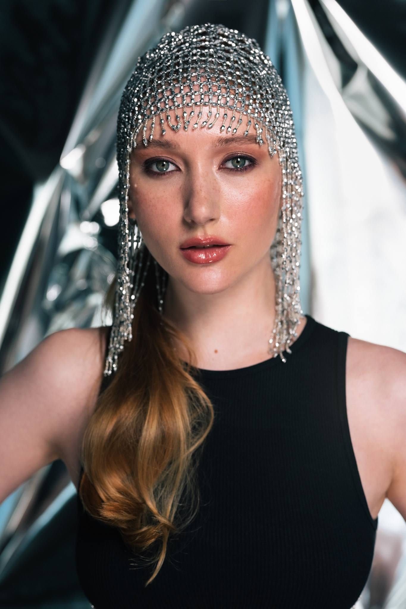 Close-up of a model in a beaded chainmail headpiece
