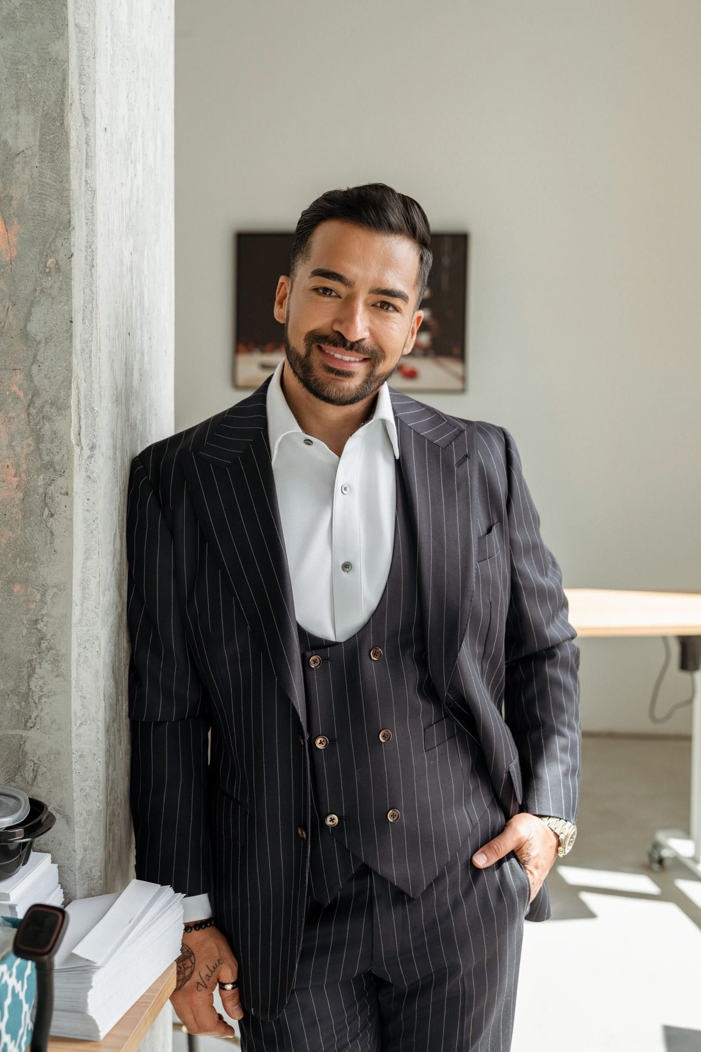 Business portrait photography, man in a pinstriped three-piece suit standing in an office