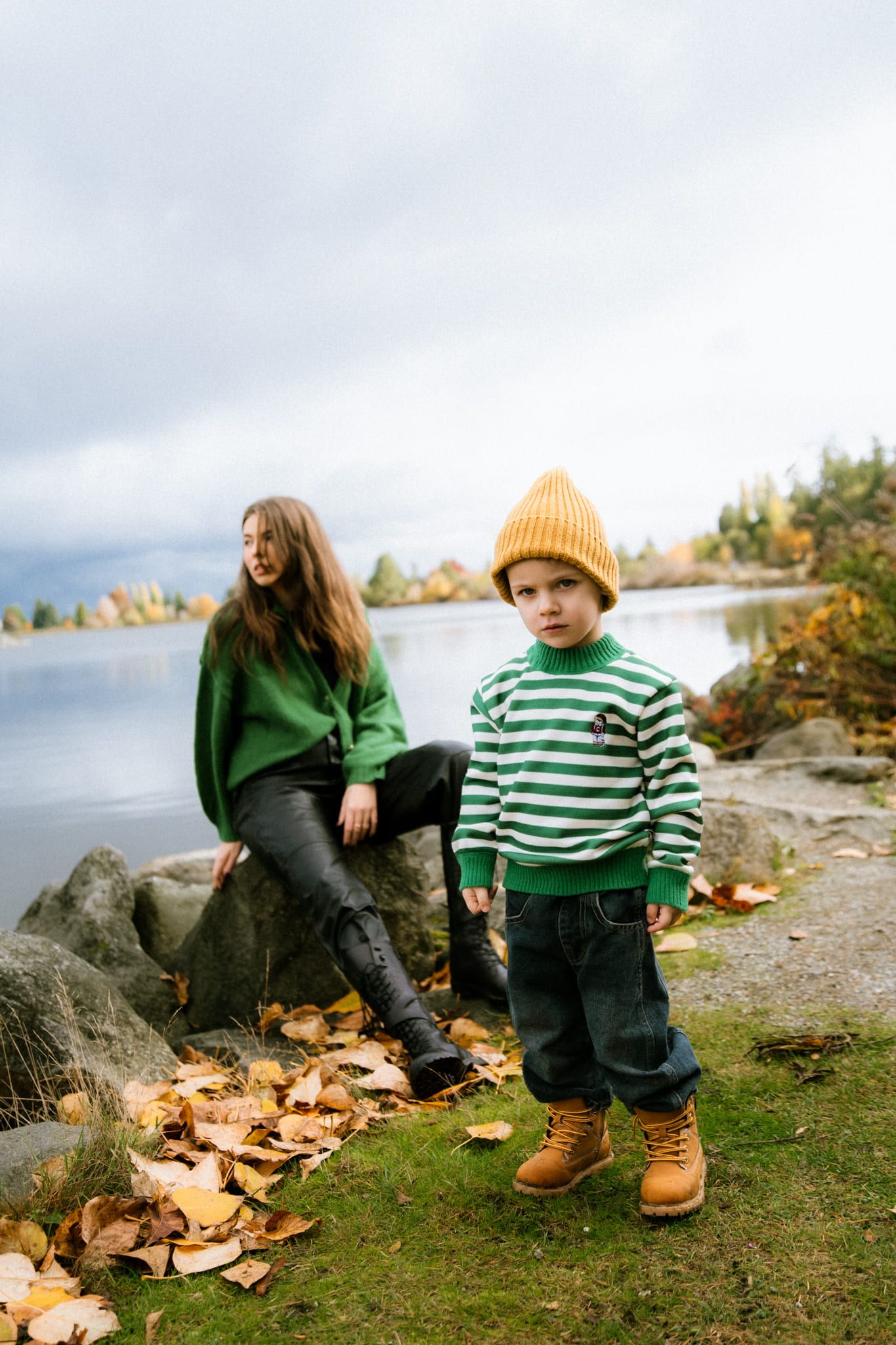 Fall family photography, mom and her young son in a striped sweater by the lake in autumn
