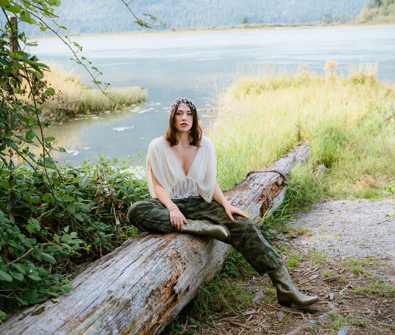 Coquitlam portrait photographer, woman in white sitting on a driftwood log by a mountain lake