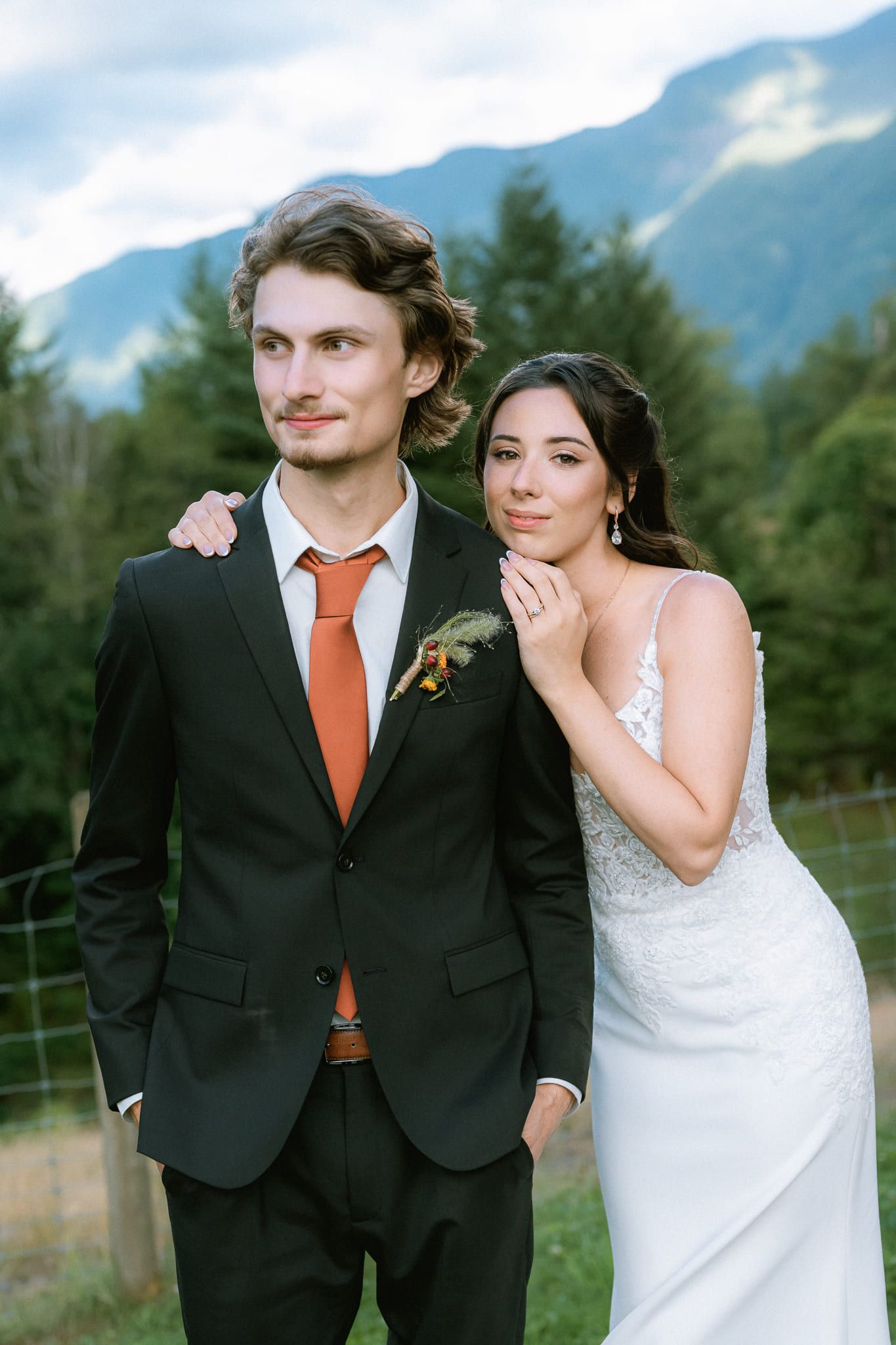 Mountain elopement photos, groom with his arm around the bride in a mountain meadow