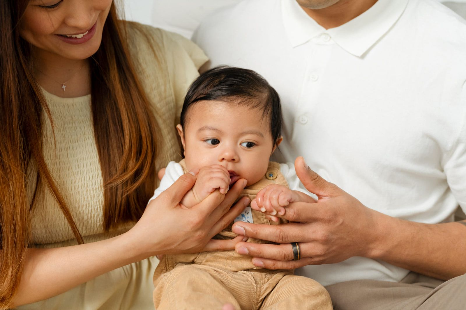 Langley newborn photos, parents holding their baby boy's hands