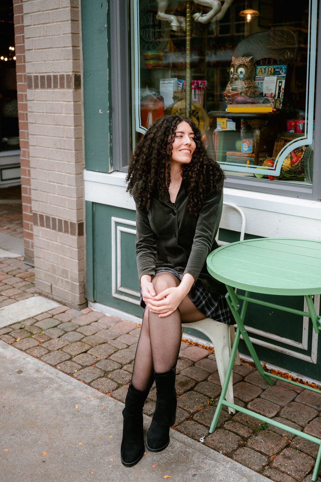 Business branding photoshoot, woman sitting at a café table outside a shop in Fort Langley Village