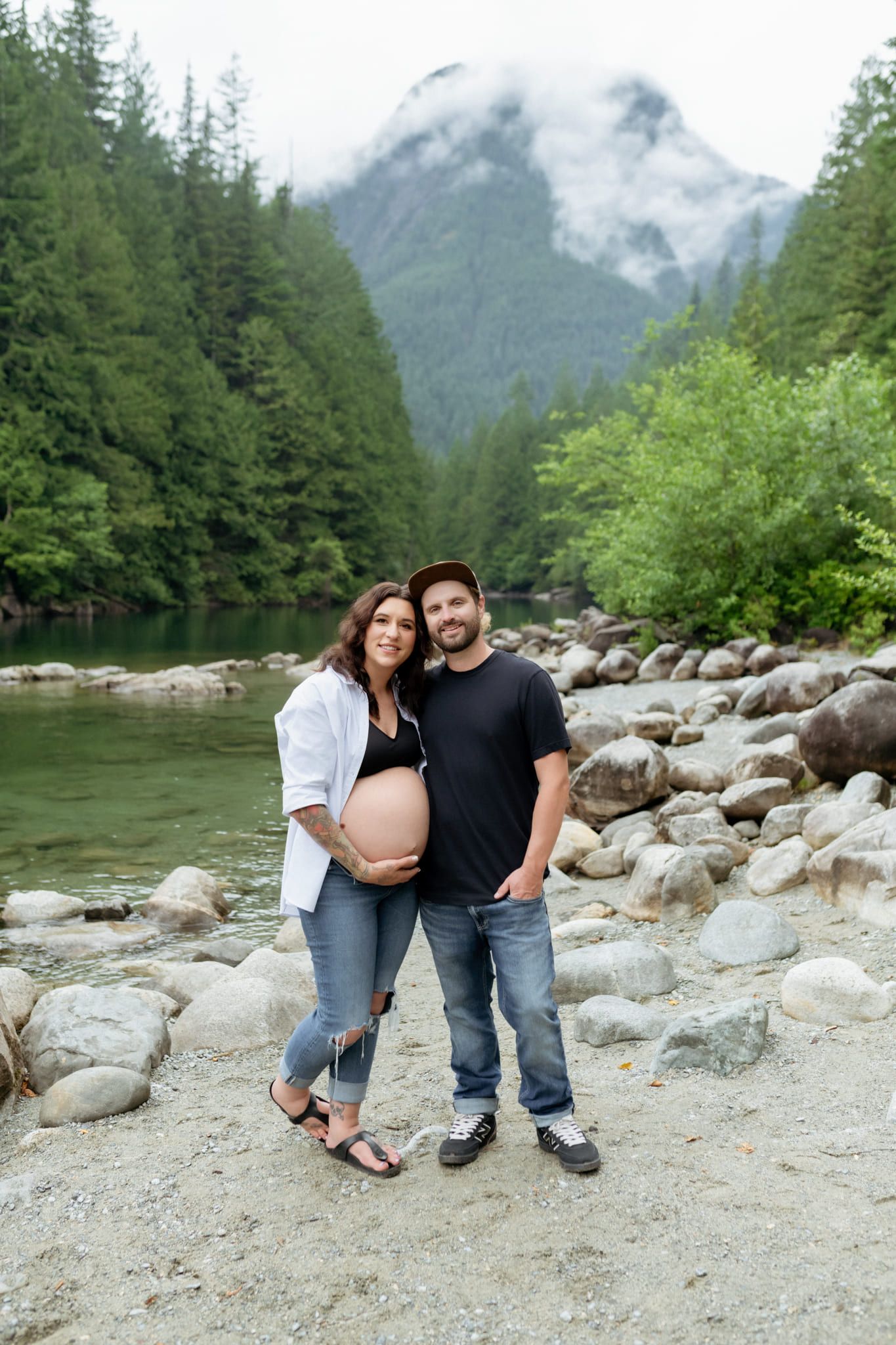 Creative unique maternity photos, expectant couple on the rocks of a mountain river