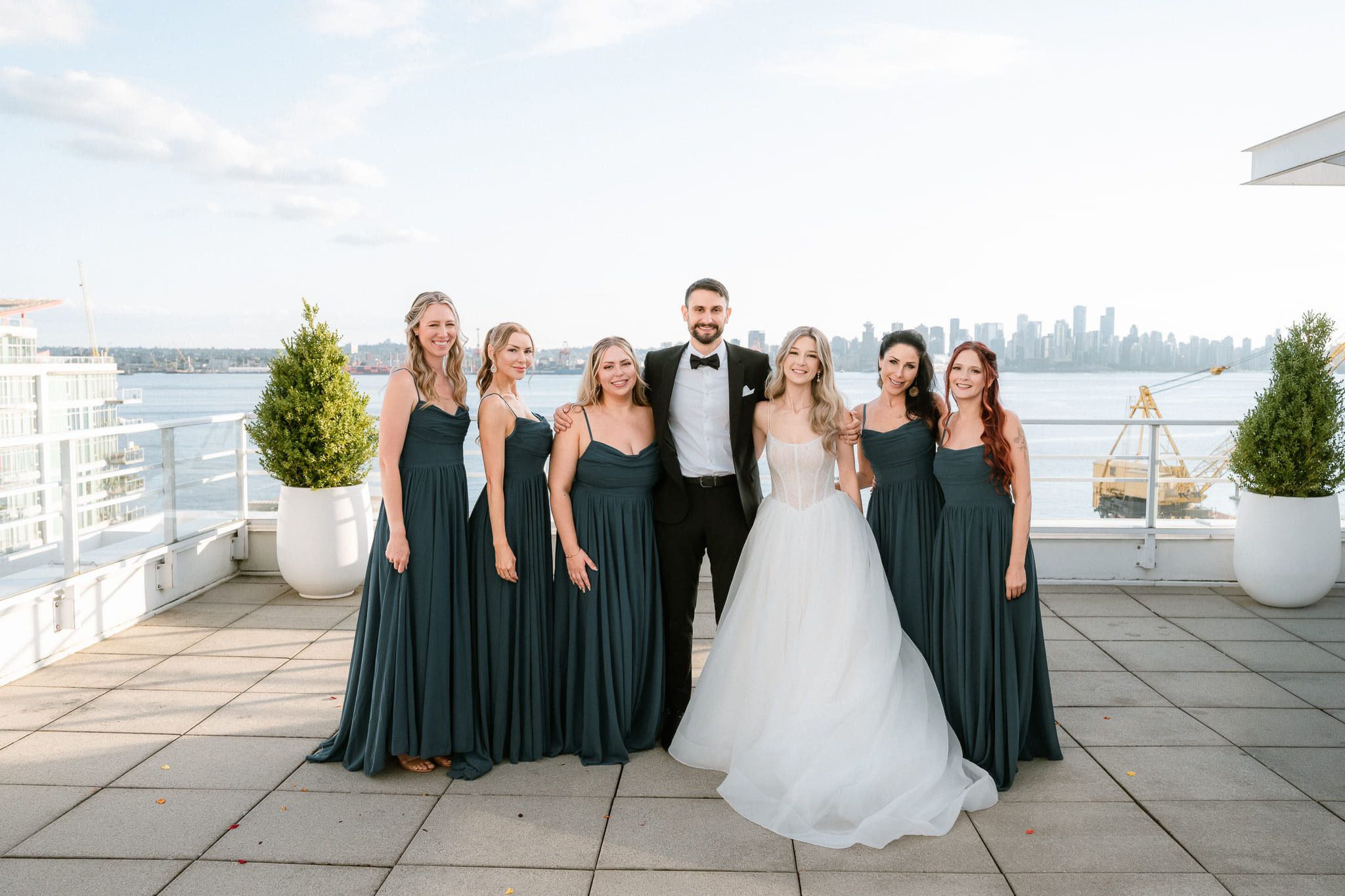 Urban wedding photos on a rooftop terrace, bride, groom and bridesmaids in green