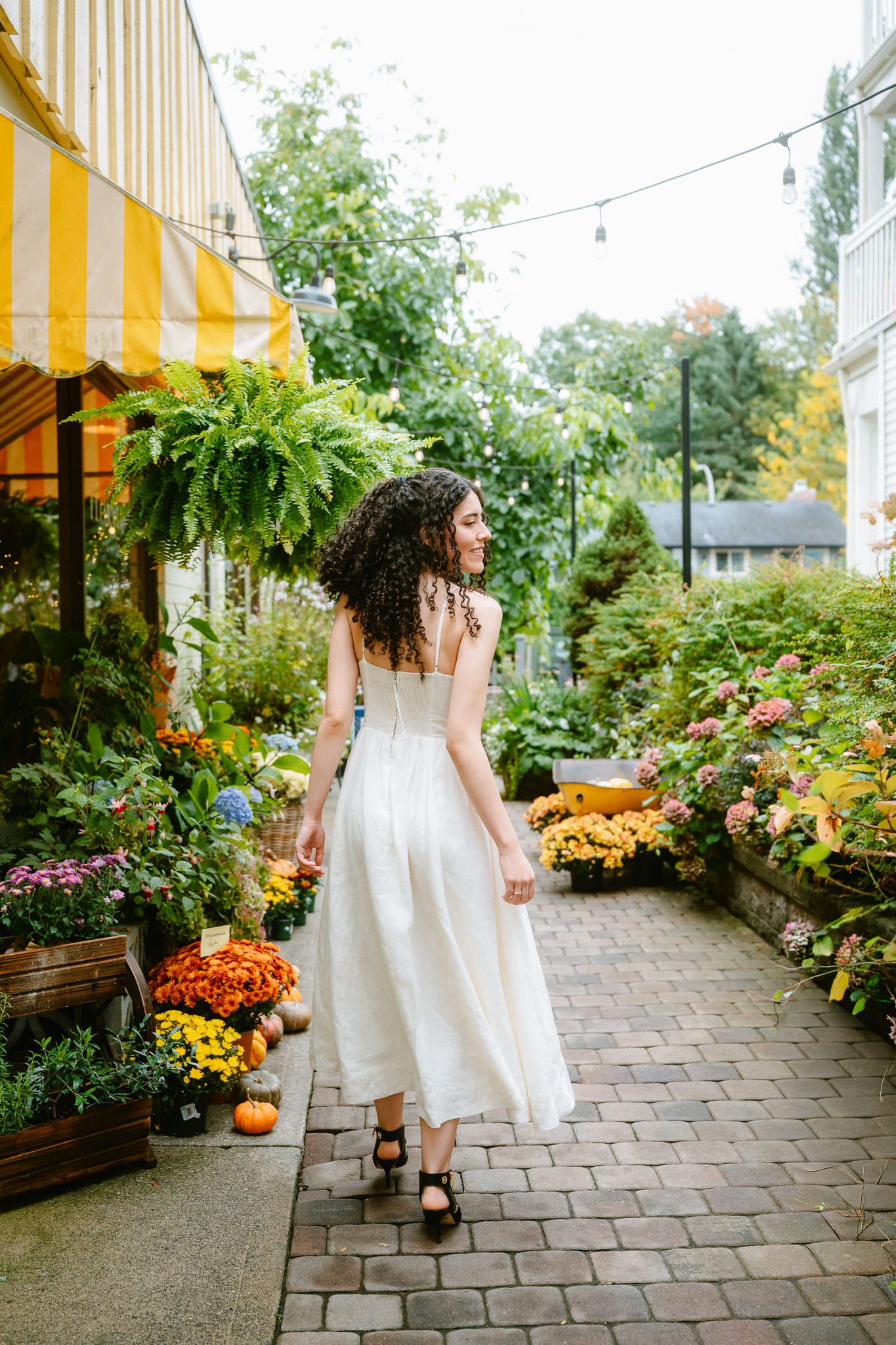 Portrait sessions on a village street, woman with curly hair