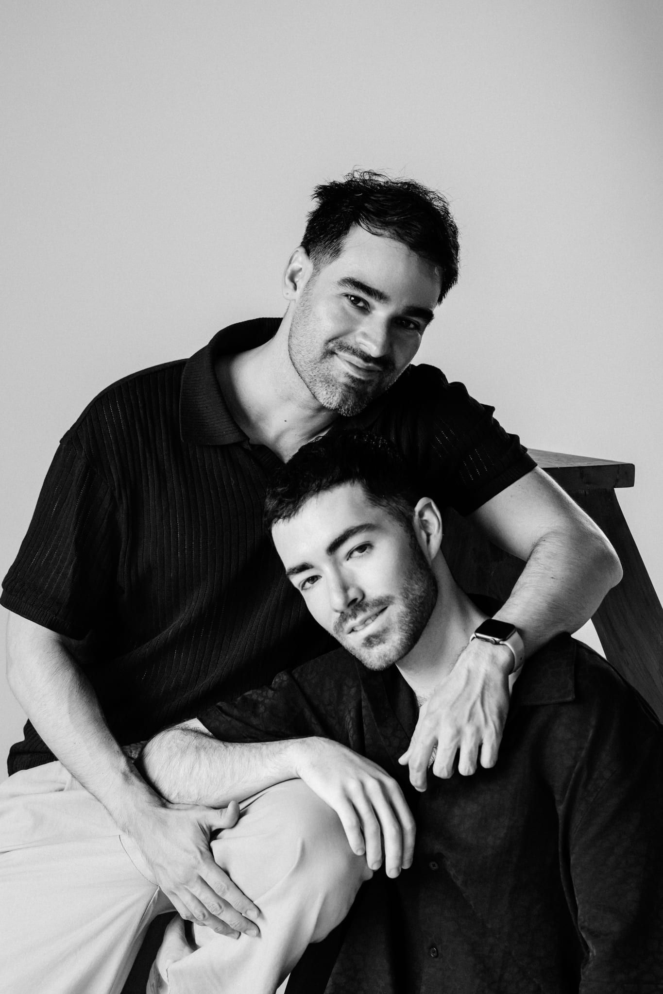 Studio engagement photos, black-and-white photo of two men posing together