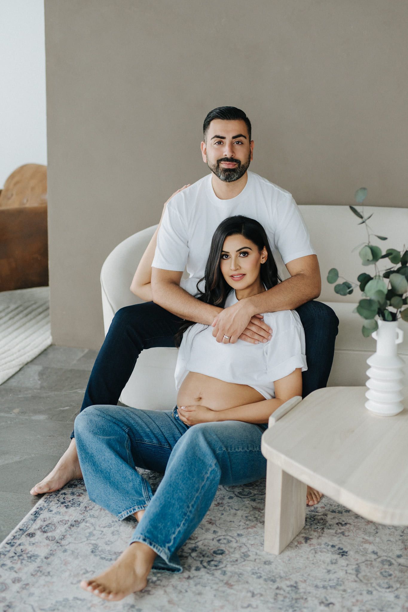 Pregnancy photography studio session, expectant couple in black in a minimalist studio
