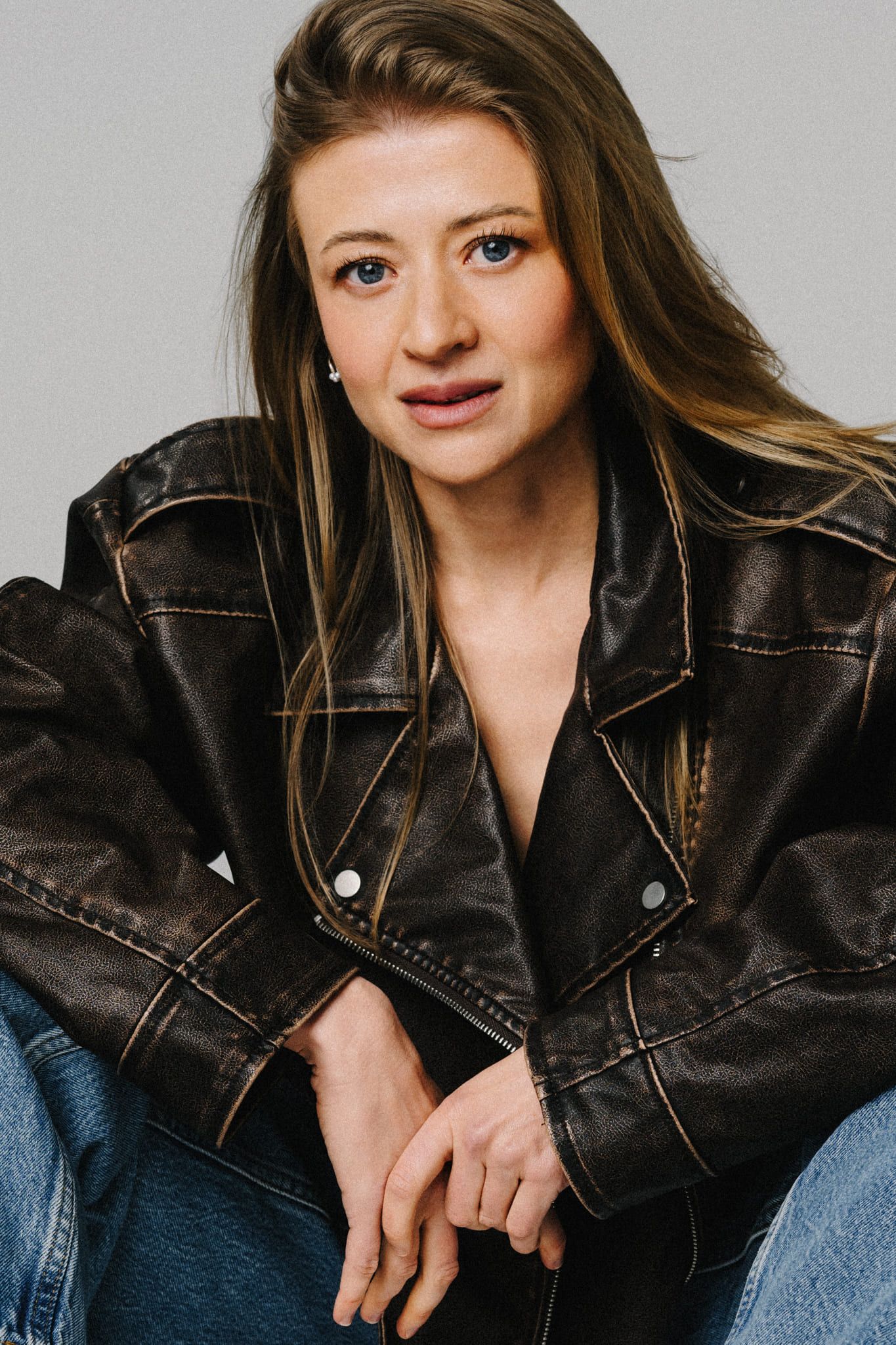 Studio portrait photography, woman in a leather jacket looking into the camera