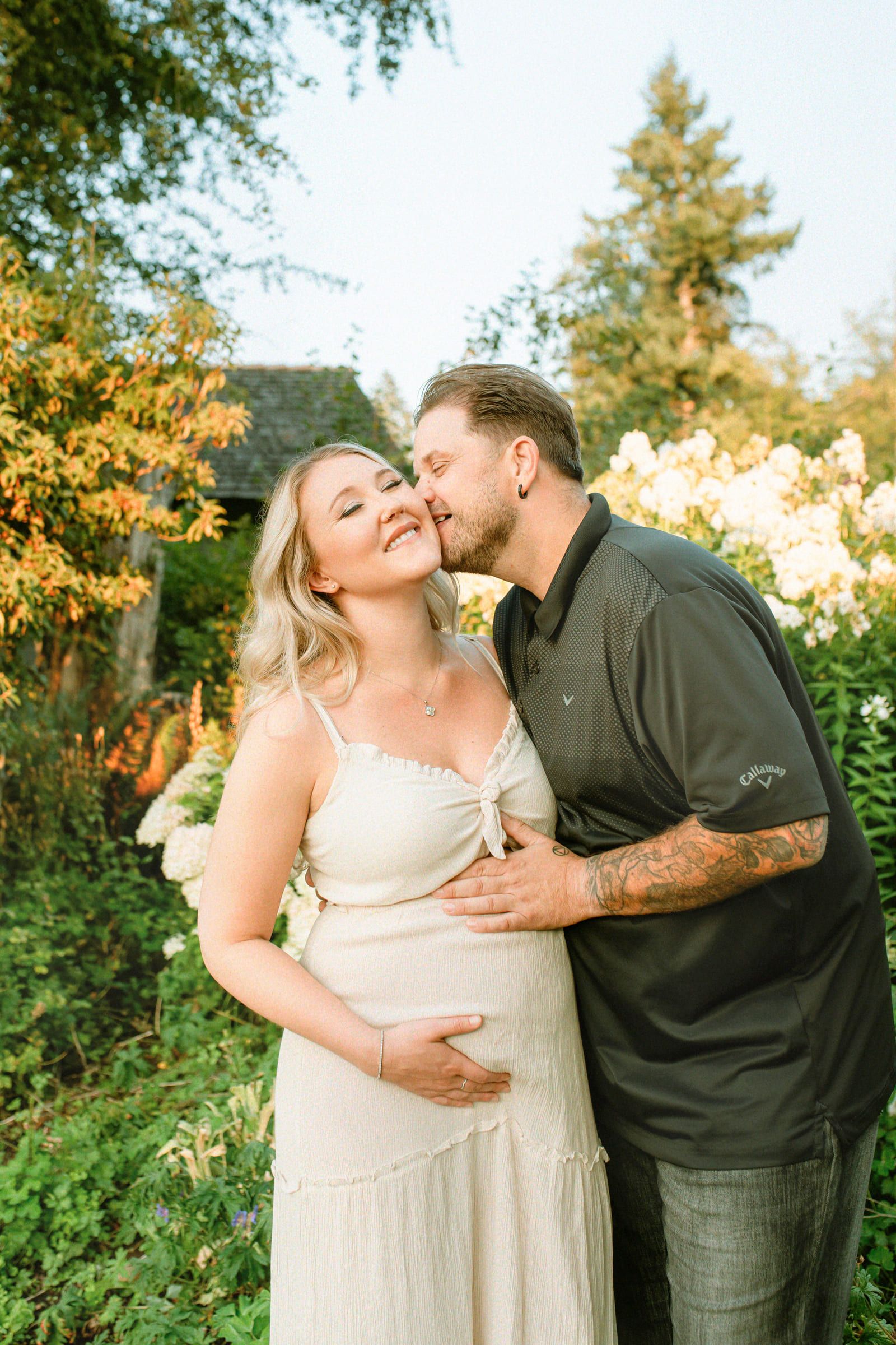 Maternity photos by the water at golden hour, expectant mother in a cream dress