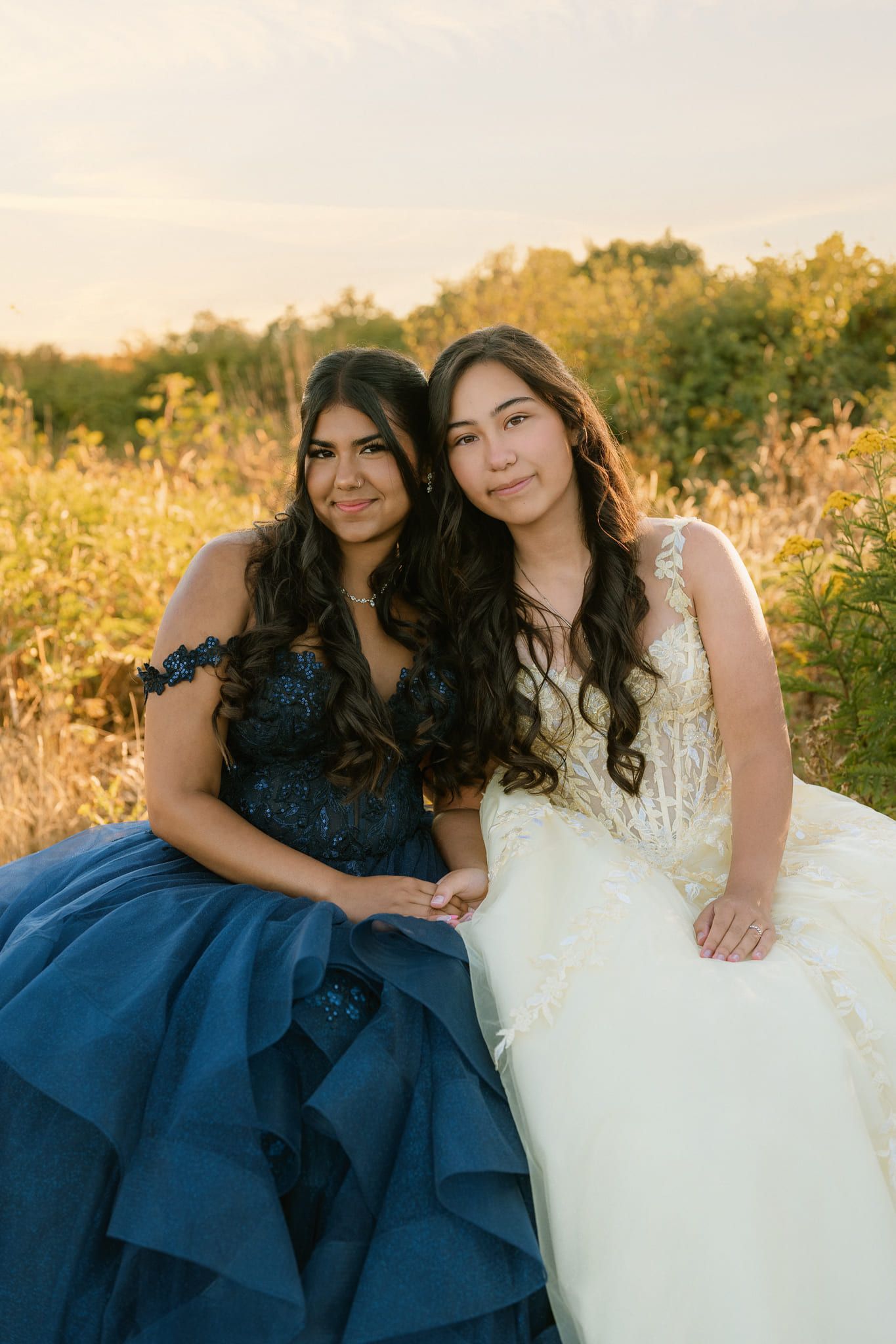 Modern portrait photography at golden hour, two young women in formal gowns