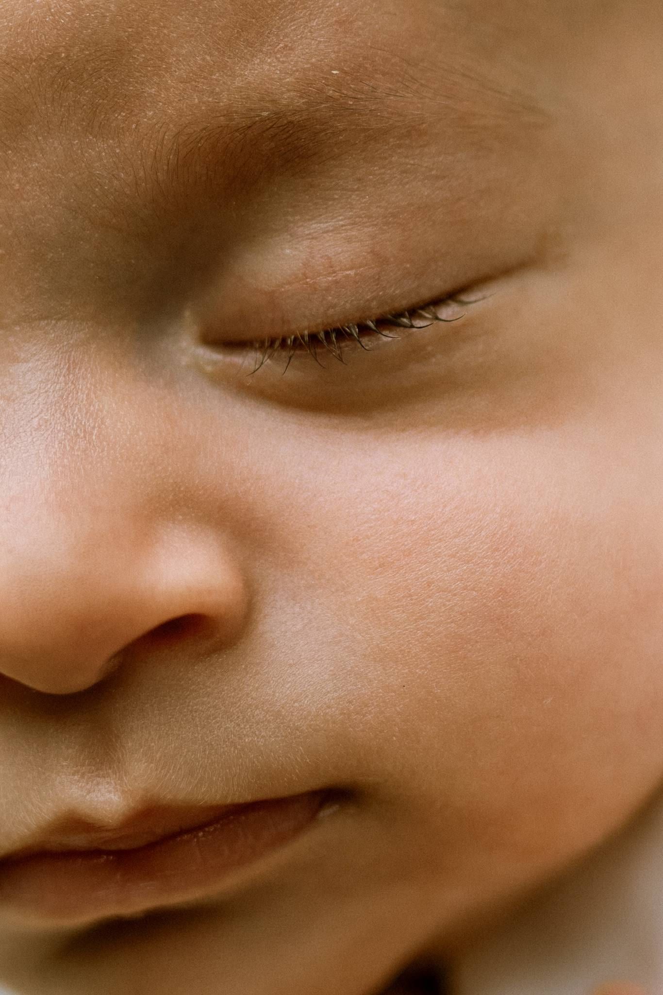 Extreme close-up of a sleeping newborn's face