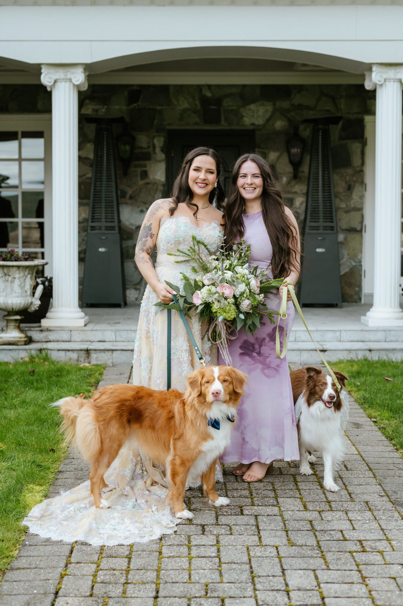 Bride and her bridesmaid with two dogs on the front path of a heritage house, by Langley elopement photographer Natalie Varro