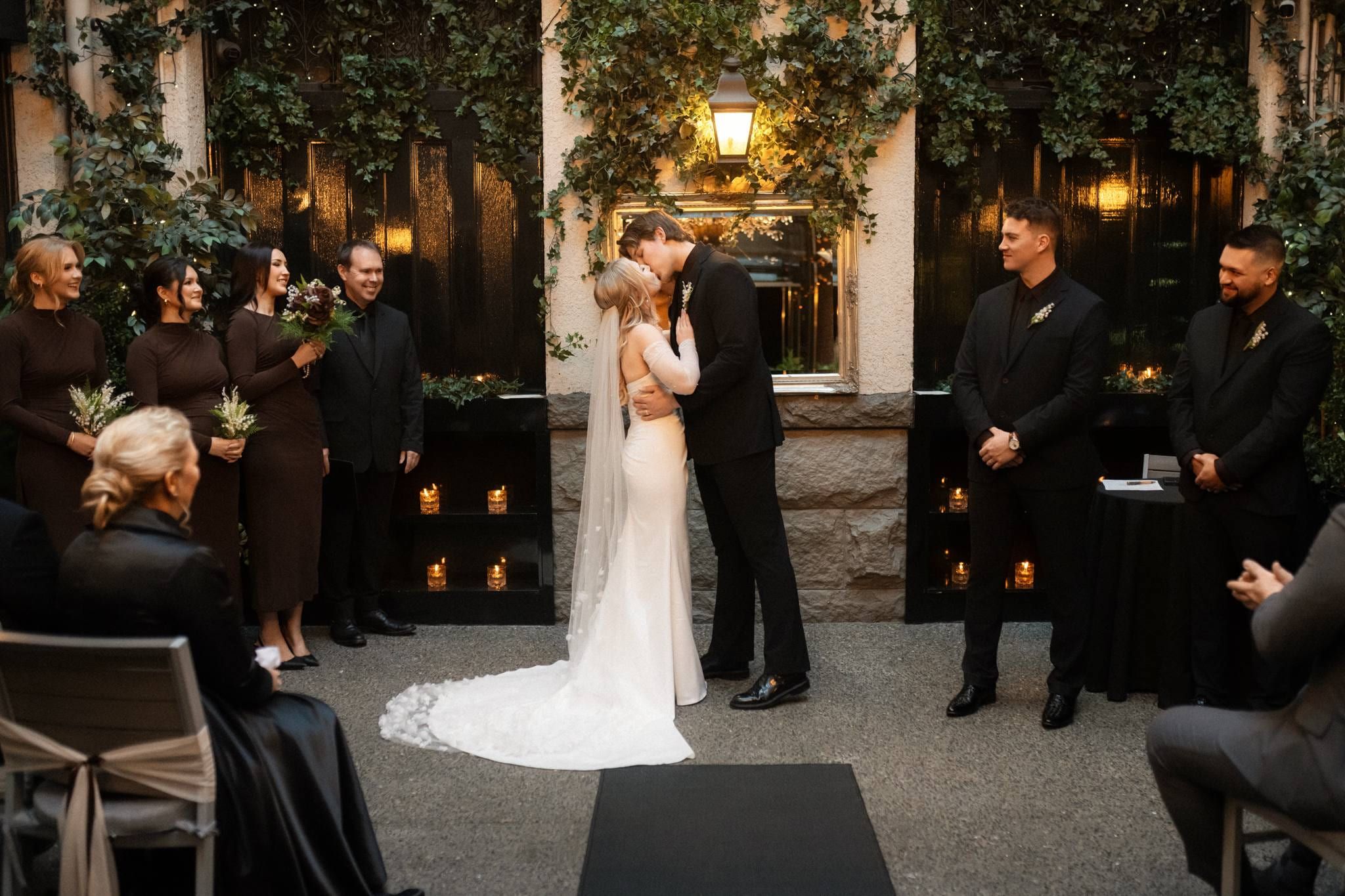 Bride and groom facing each other before their guests in the courtyard
