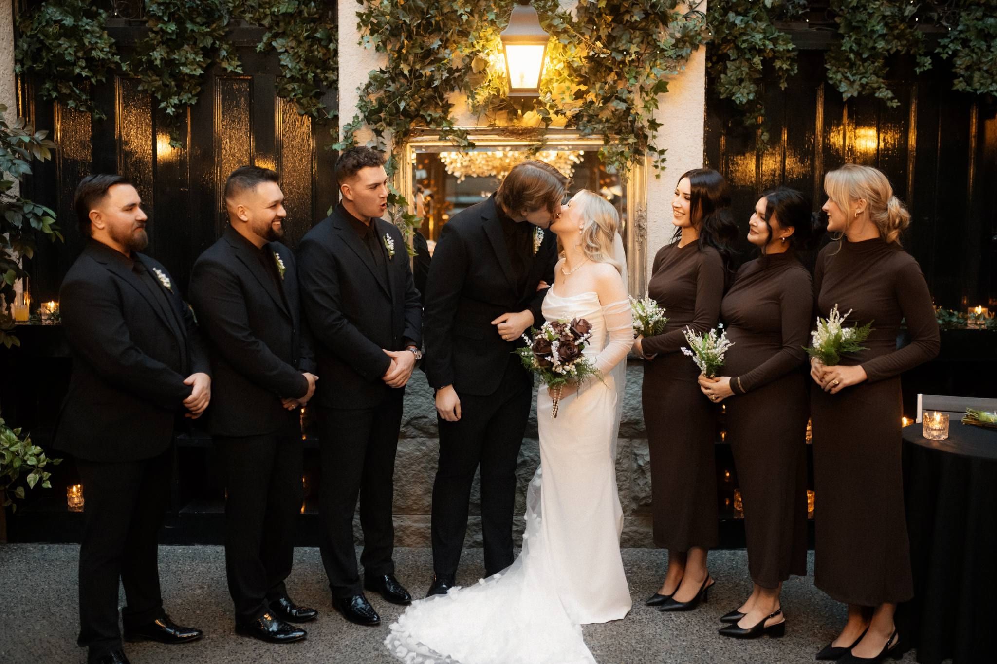 Bride and groom with their wedding party in the courtyard