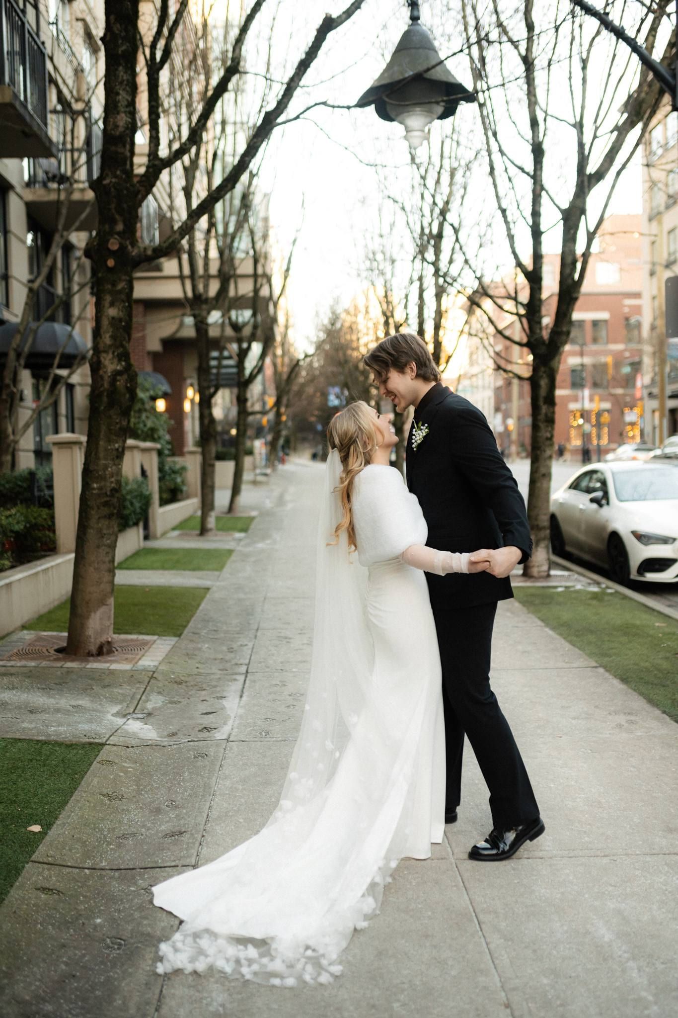 Couple facing each other on a tree-lined city street