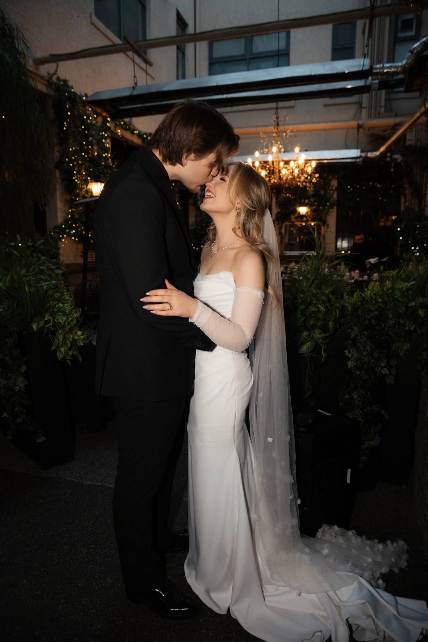 Couple kissing in the candlelit courtyard at night