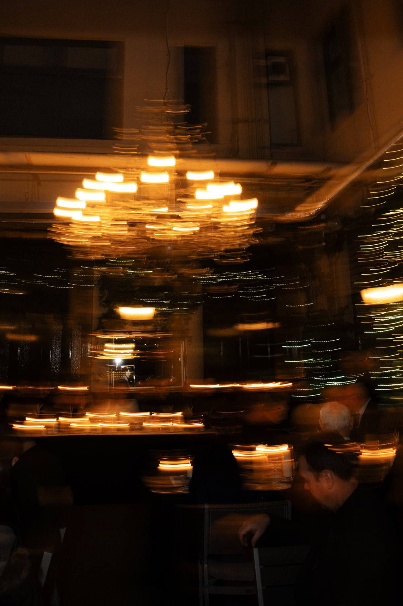 Chandelier glowing in the dimly lit reception room