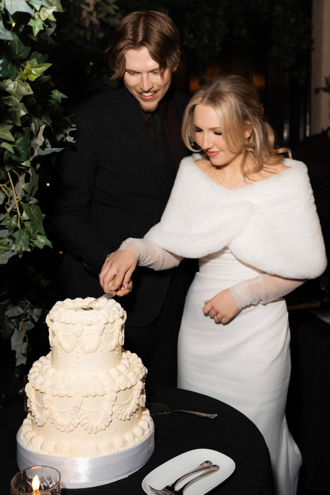 Bride serving the groom a slice of wedding cake