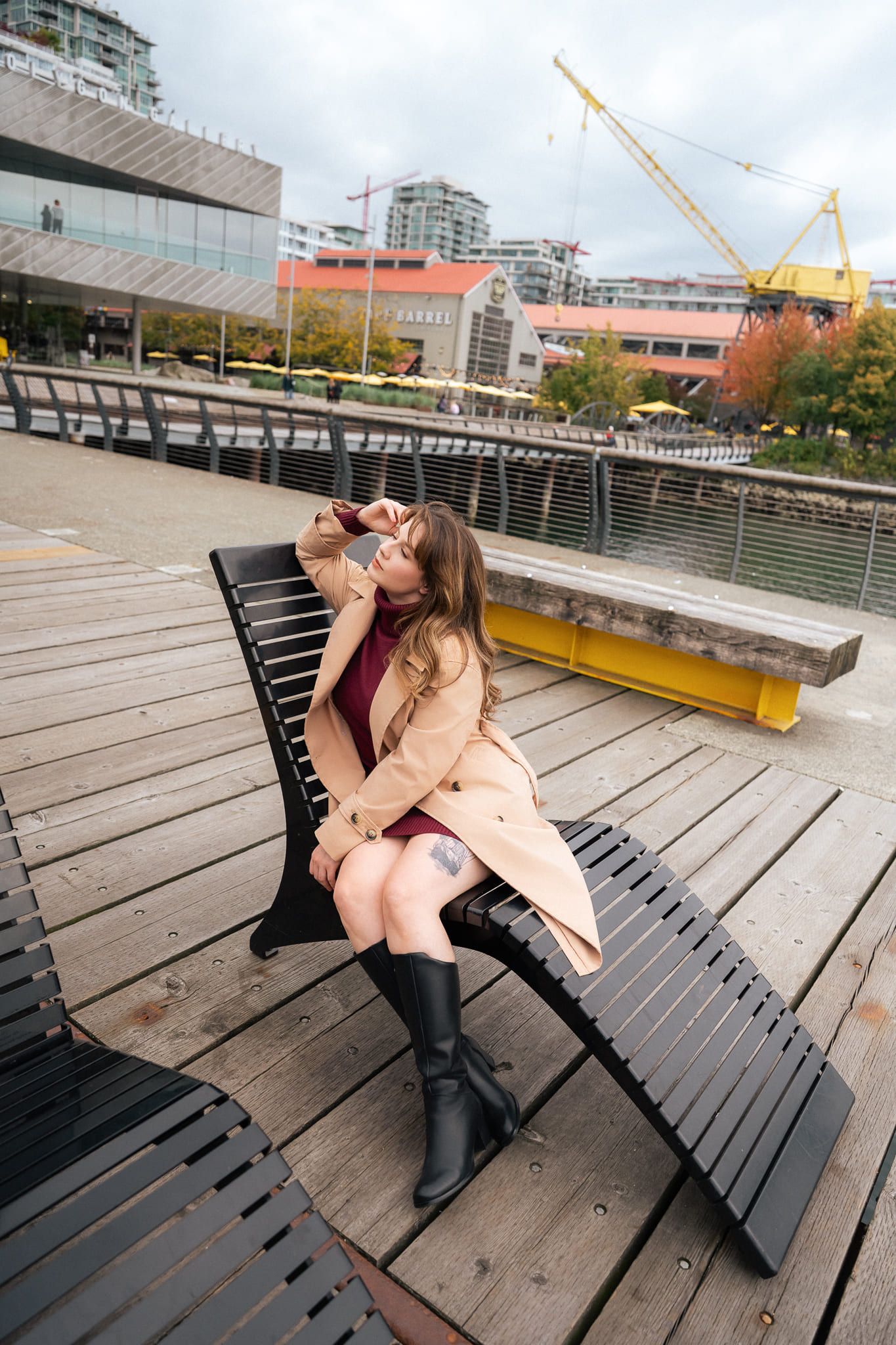 Branding photoshoot on the waterfront, woman in a camel trench coat