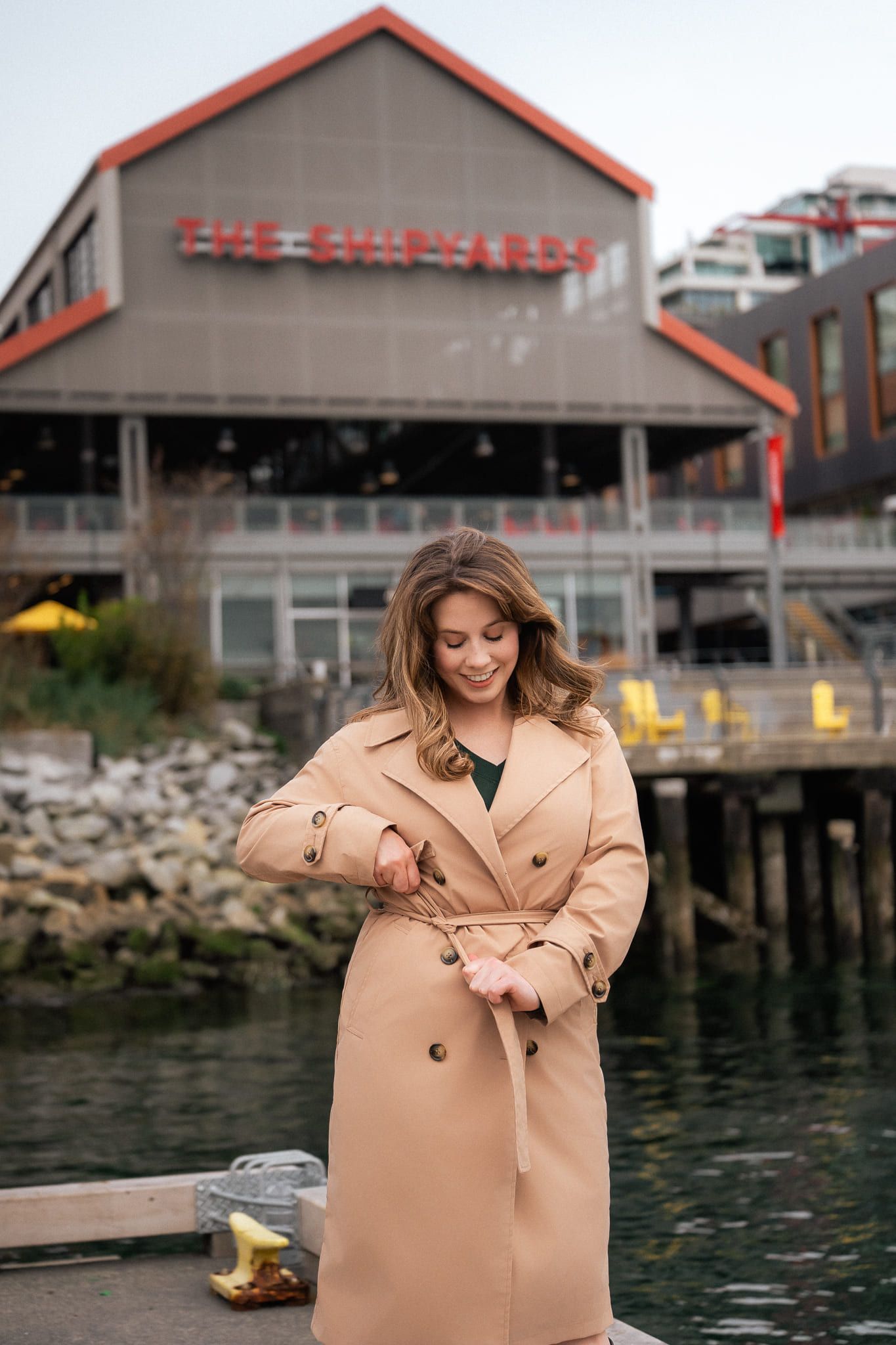 Professional branding photos on the waterfront, woman in a camel trench coat