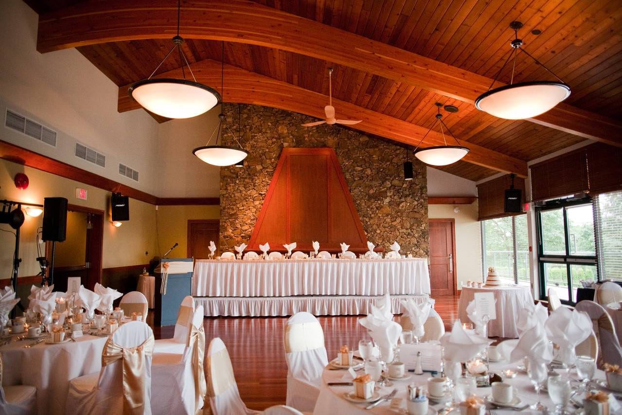 Intimate wedding photos, clubhouse room with a head table below a stone fireplace