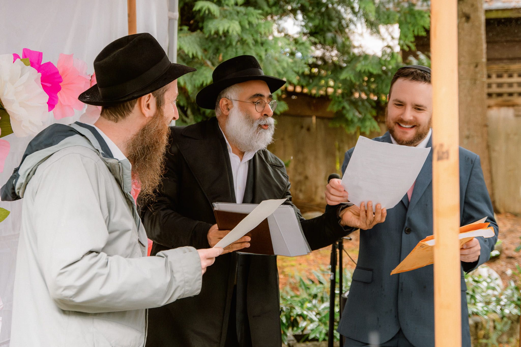 Elopement pictures, wedding ceremony with a rabbi reading under a canopy