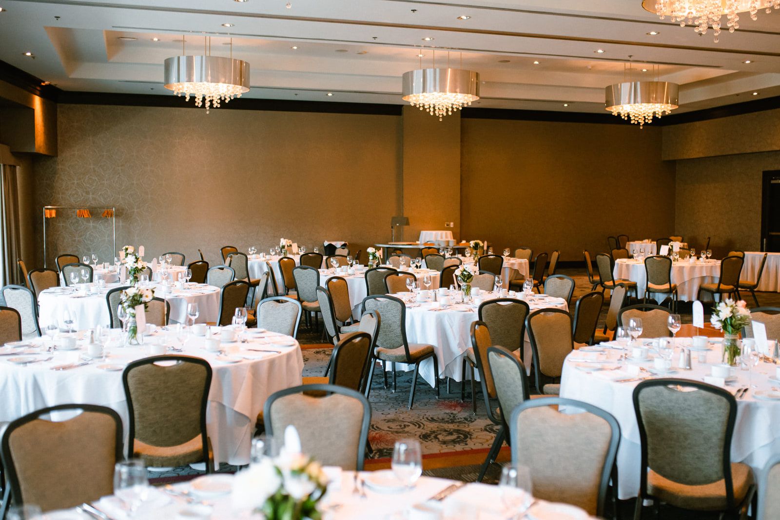 Elopement photos, reception room set with round tables and white linens