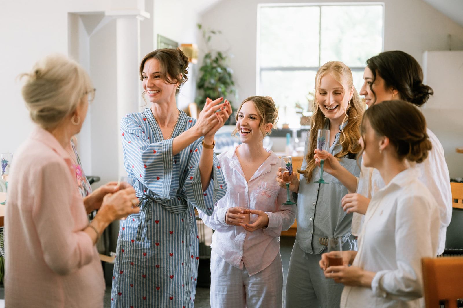 Wedding photography in Langley, bride laughing with her bridesmaids while they get ready