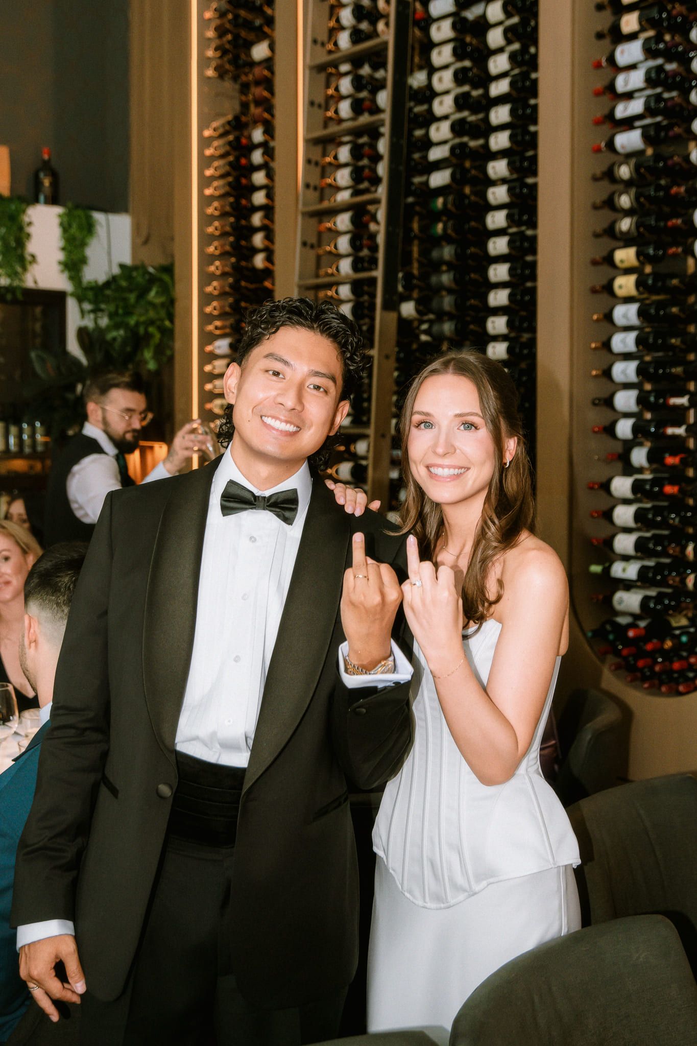Wedding details photography in a wine room, bride and groom showing their rings