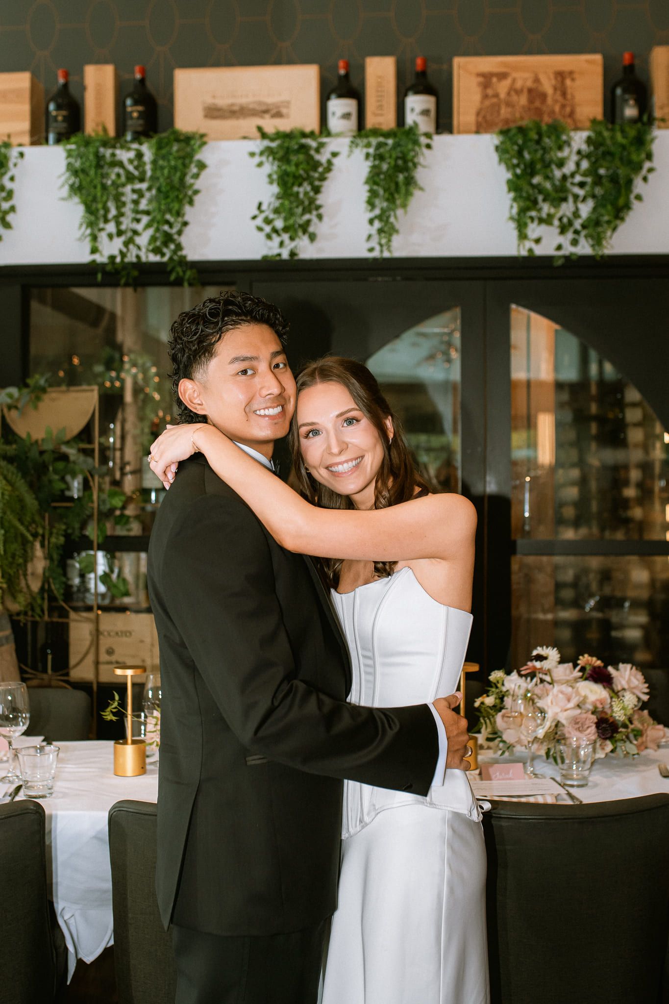 Pre-bridal shoot, bride and groom hugging in a decorated reception room